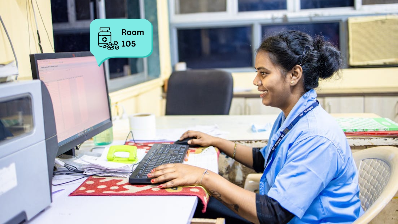 Patient pressing a Trackerwave BLE wristband call button while a nearby nurse receives the alert on an e-ink coaster
